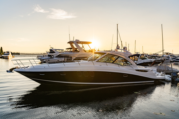Luxury yacht in the evening sunset. Yacht club marina. Summer vacation. Downtown city marina with luxury yacht. Docked vessels. Luxury yacht in sunset marina Luxury yacht in the evening sunset. Yacht club marina. Summer vacation.